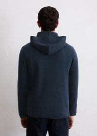 Hooded sweatshirt in dark navy, featuring a textured knit design, relaxed fit, and a slightly raised collar. Accents include a kangaroo pocket.