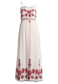 Maxiklänning i lätt cremefärgad tyg, med intrikata röda blommönsterbroderier, justerbara spagettiband och en samlad midja.