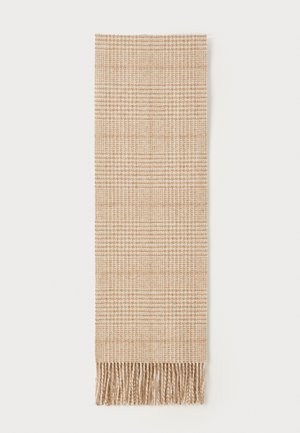 Sciarpa intrecciata beige con un motivo a quadri testurizzato e bordi frangiati. Il tessuto appare morbido e leggero, adatto per sovrapporre.