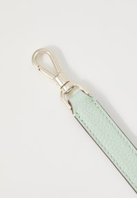Mint green leather strap with textured finish, featuring a silver metal swivel clasp and stitched edges for added durability.