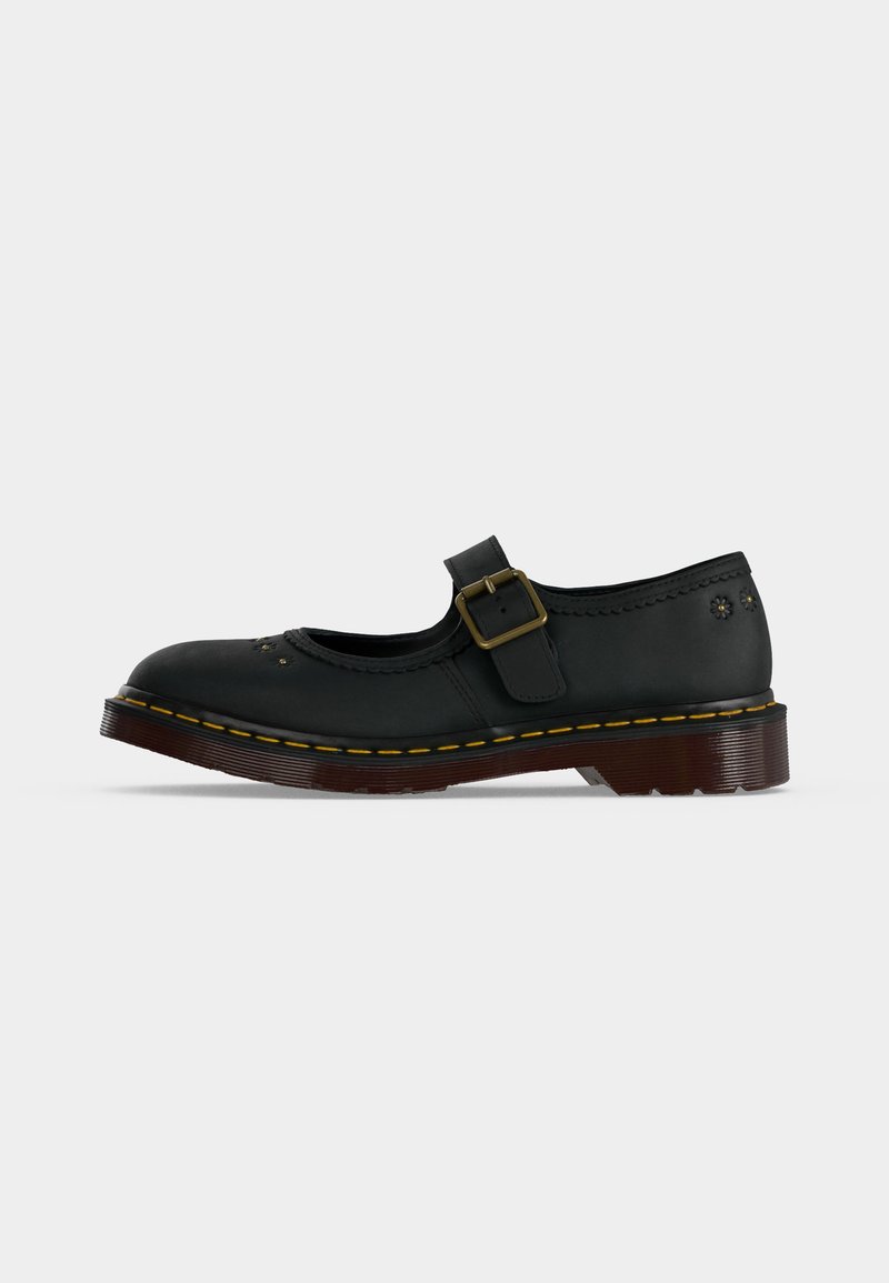 Scarpa Mary Jane in pelle nera con cinturino con fibbia, cuciture gialle lungo la suola e piccoli fori decorativi a forma di fiore sulla punta e sul tallone.