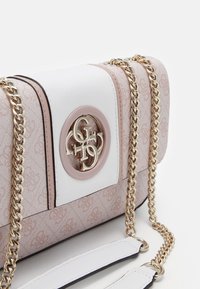 Pink and white crossbody bag featuring a logo medallion, gold chain strap, textured material, and a subtle pattern on the surface.
