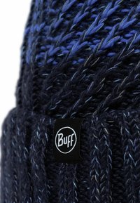 Dark blue knitted beanie featuring a textured pattern with lighter blue strands and a black "Buff" logo patch on the side.