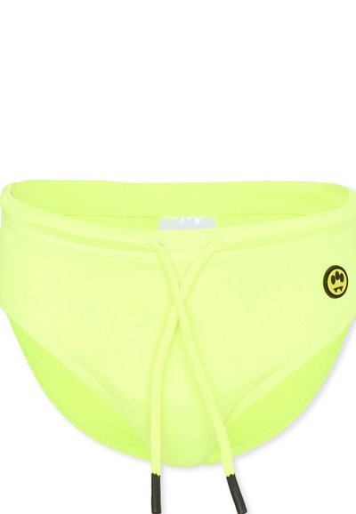 Slip de bain jaune néon avec cordon de serrage à l'avant et petit logo circulaire noir représentant une empreinte de patte et des crocs sur le côté droit.