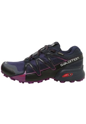 Mørkelilla og sort Salomon trail løbesko med robust sål, Gore-Tex mærke og letvægts muskelteknologi badge.