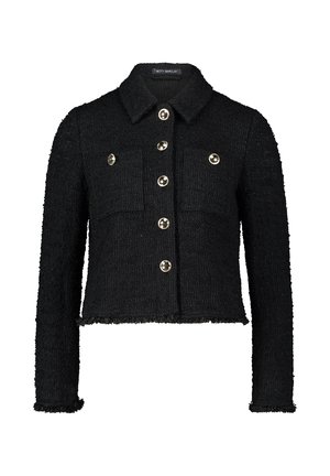 Veste en tweed noir avec une coupe courte, fermeture à boutons, deux poches poitrines et boutons métalliques. Ourlet effiloché et détail de tissu texturé.