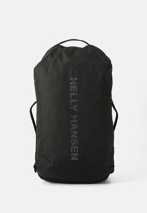 Black backpack made of textured nylon, featuring a top handle, adjustable straps, and “HELly HANSEN” logo in reflective print on the side.