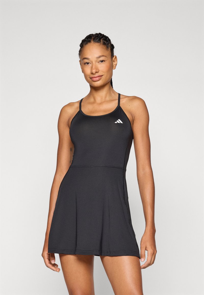 Black athletic dress with a fitted bodice and flared skirt. Features thin straps and a small white logo on the left chest area. Smooth fabric texture.
