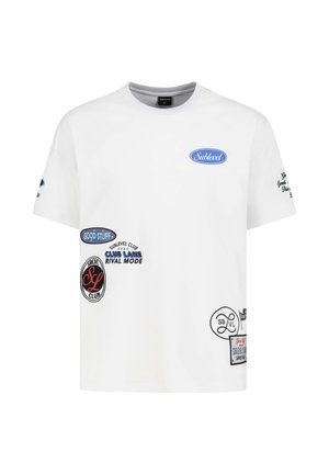 White short-sleeve t-shirt with multiple small printed patches and logos in blue, black, and red, including text like "Sublevel" and "Good Stuff."
