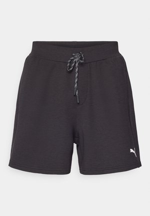 Shorts de sport noirs avec une taille élastique et un cordon de serrage réglable. Présente un petit logo blanc sur le côté gauche. Texture de tissu douce.