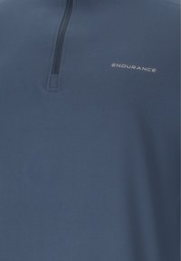Navy blue quarter-zip top with "ENDURANCE" logo on the chest, showing zipper detail and smooth fabric texture.