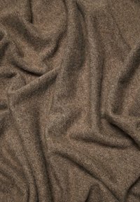 Brown textured fabric draped loosely, showcasing a soft, woven surface with subtle variations in tone and depth.