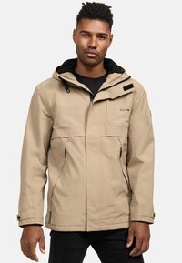 Beige hooded jack met een ritssluiting aan de voorkant, twee grote zijzakken en zwarte accenten. Gemaakt van lichtgewicht stof met een gladde textuur.