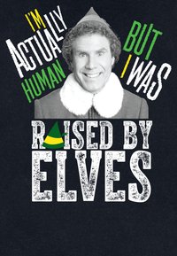 T-shirt nera con un personaggio sorridente dai capelli ricci e un cappello da elfo. Il testo include frasi in verde, giallo e bianco, con un elemento decorativo sul cappello.