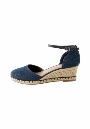 Denim wedge sandal featuring a round toe, ankle strap, and natural rope detailing on a side-wrapped heel. Color: dark blue.
