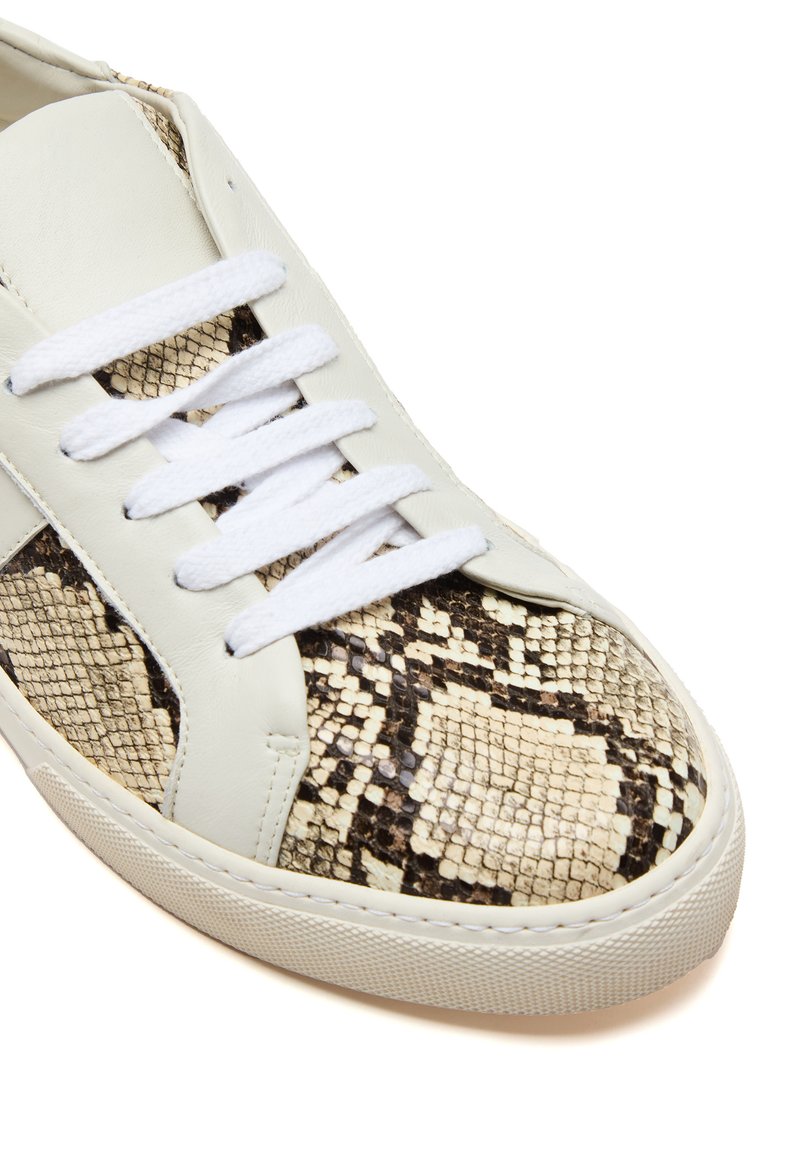 Weiße Leder-Sneaker mit einer strukturierten, schlangenmusterartigen Seitenpartie in Beige und Braun, weißen Schnürsenkeln und einer Gummisohle.