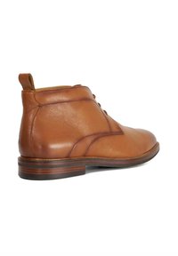 Brown leather ankle boots with a smooth texture, rounded toe, lace-up front, and a contrasting dark wood heel. Clean, minimal design details.