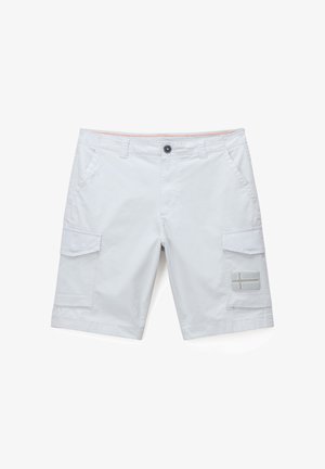 White cargo shorts with side pockets, button closure, belt loops, and a small flag patch on the right leg pocket.