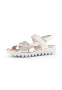 Beige and metallic open-toe sandal with crisscross straps, adjustable ankle strap, and a textured white rubber sole featuring ridged edges.