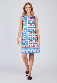 Bunt gemustertes Kleid in Blau, Pink und Rot. Verfügt über geometrische Designs, ärmellosen Schnitt und einen knielangen Saum. Kombiniert mit schwarzen Sandalen.