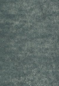 Close-up of soft, textured fabric with a tightly woven pattern in varying shades of muted blue-gray.