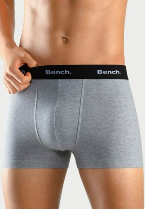 Gray boxer shorts made of cotton blend, featuring a black elastic waistband with "Bench." logo in white. Soft texture, fitted design.