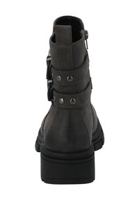Botín de tobillo de cuero sintético negro con dos correas decorativas, detalles en hardware plateado, un tacón grueso y un acabado texturizado.