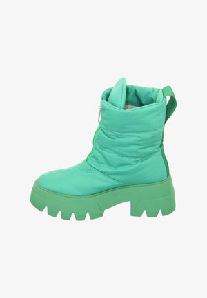 Chunky mint green winter boot with high padded ankle, thick ridged sole, zipper closure, and pull tab at back.