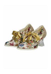 Zapatos con estampado floral que presentan una parte superior beige con lazos de satén amarillos y un tacón de bloque transparente. Los bordes adornados añaden detalle.