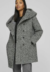Wool-blend coat in gray and black, featuring a wide collar, double-breasted button closure, and side pockets with textured fabric.