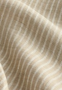 Woven fabric featuring a beige background with alternating white striped patterns. The texture is soft and textured.
