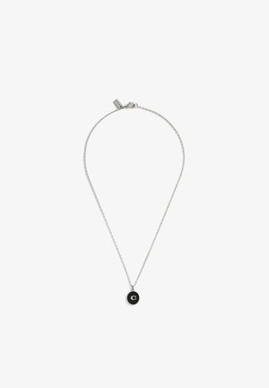 Silver chain necklace with a circular black pendant featuring a white letter "C." Chain is thin with a lobster clasp closure.