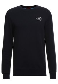 Sudadera azul marino de algodón con cuello redondo, mangas largas, puños y dobladillo acanalados, que presenta un pequeño logo blanco en el pecho.