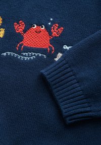 Marineblå strikket sweater med en rød broderet krabbe, med ribkanter og dekorative bølger samt maritime elementer i forskellige farver.