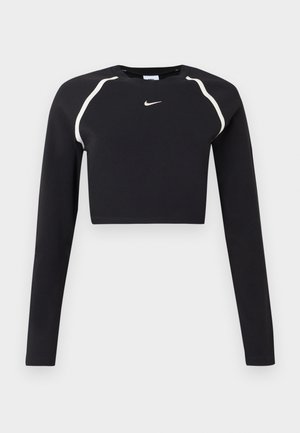 Black long-sleeve cropped athletic top with white curved shoulder stripes and small white Nike swoosh logo at chest center.