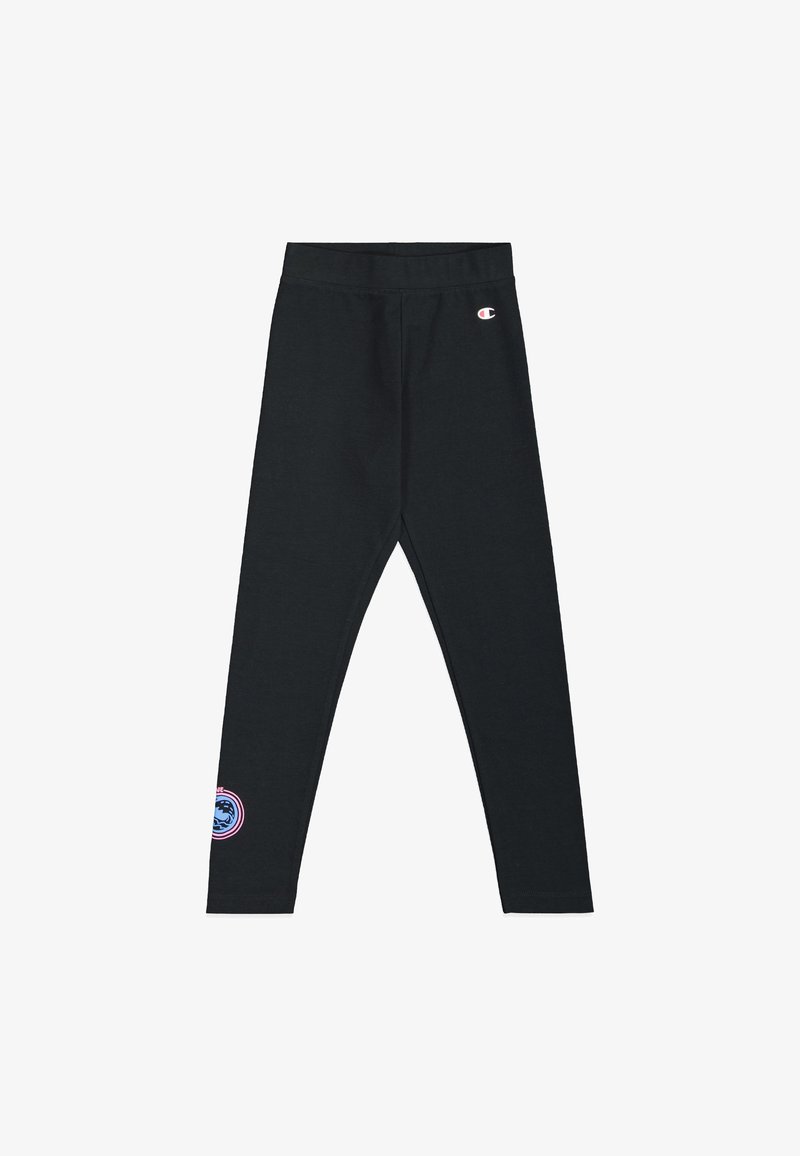 Leggings noirs avec une texture douce et une taille élastique, présentant un patch logo rond en rose et bleu sur le bas de la jambe gauche.