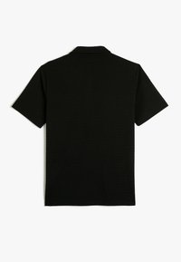 Czarna koszulka polo z krótkim rękawem i kołnierzykiem, wykonana z gładkiego, teksturowanego materiału, o prostym, minimalistycznym designie, bez ozdób.