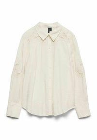 Chemise crème boutonnée, avec un col et des détails en dentelle sur les épaules. Manches longues avec poignets boutonnés, confectionnée dans un tissu léger.