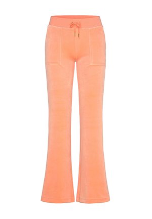 Wijde joggers van zacht, perzikkleurig fluweel met een elastische tailleband, trekkoorddetail en twee steekzakken aan de voorkant. Gladde textuur.