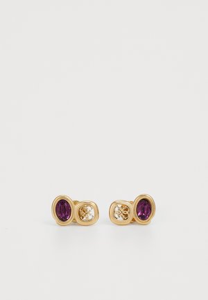 Gold metal earrings featuring two oval purple stones, with an intricate cut-out design between the stones. Smooth texture and polished finish.