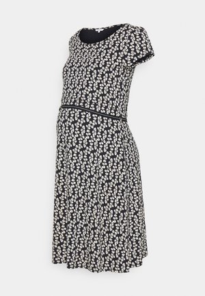 Vestito premaman blu navy con motivo floreale bianco. Maniche corte, scollo tondo, corpino aderente e orlo svasato. Tessuto morbido ed elasticizzato.