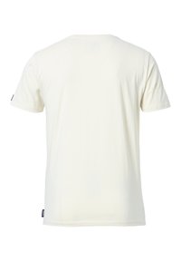 Camiseta de algodón color crema con mangas cortas, cuello en V y una pequeña etiqueta negra en la manga izquierda. Textura suave, diseño básico.