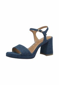 Denimist kontsaga sandaalid, mis on varustatud laia esirihmaga, pahkluu rihmaga klambriga ja paksu kontsaga. Heledat pruuni sisetalla ja tekstuuriga denimkangast.