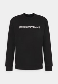 Felpa nera con maniche lunghe, scollatura rotonda e polsini a costine. Presenta il logo bianco "EMPORIO ARMANI" sulla parte anteriore. Tessuto morbido.