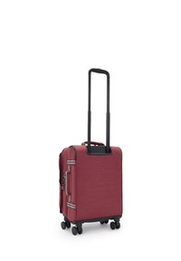 Red fabric luggage with a telescopic handle and multiple wheels. Features side zippers and a textured surface. Accents in black and blue.