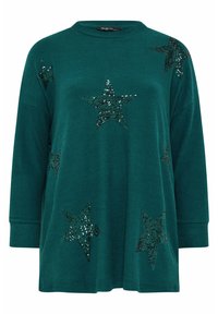 Pull oversized teal avec des manches longues, orné de plusieurs étoiles en sequins noirs. Tissu doux avec un col rond et une coupe décontractée.