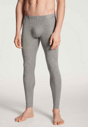 Graue lange Leggings aus einem weichen, dehnbaren Stoff. Sie verfügen über einen glatten Bund und eine enganliegende Passform entlang der Beine. Keine sichtbaren Muster.