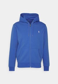 Blå zip-up hoodie gjord av fleecetyg. Har en huva med dragsnöre, två framfickor, ribbade muddar och en liten logotyp på bröstet.