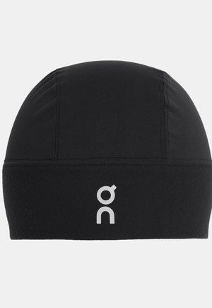 Black sports beanie made from soft fabric with a smooth texture, featuring a white logo on the front and a seam across the center.
