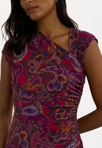 Vestido justo com um padrão vibrante em paisley nas tonalidades de roxo e rosa. Apresenta um decote drapeado e mangas curtas, com detalhes franzidos nas laterais.